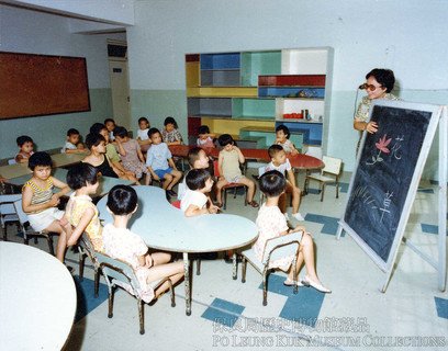 Class at the “Retarded Children Section”. A teacher is using visual aids to stimulate interest in learning.