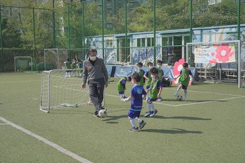 保良局主席陳正欣博士, MH參與足球遊戲，與學生打成一片。